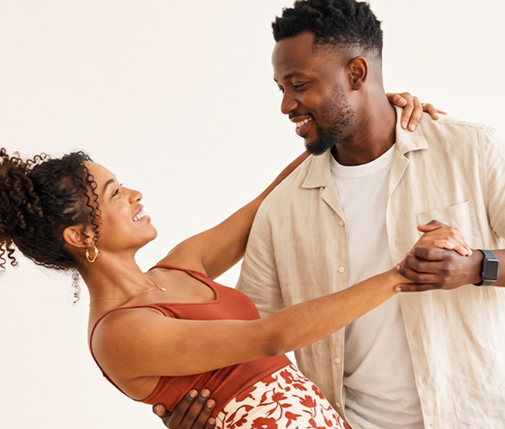 Couple holding hands while learning a social dance turn